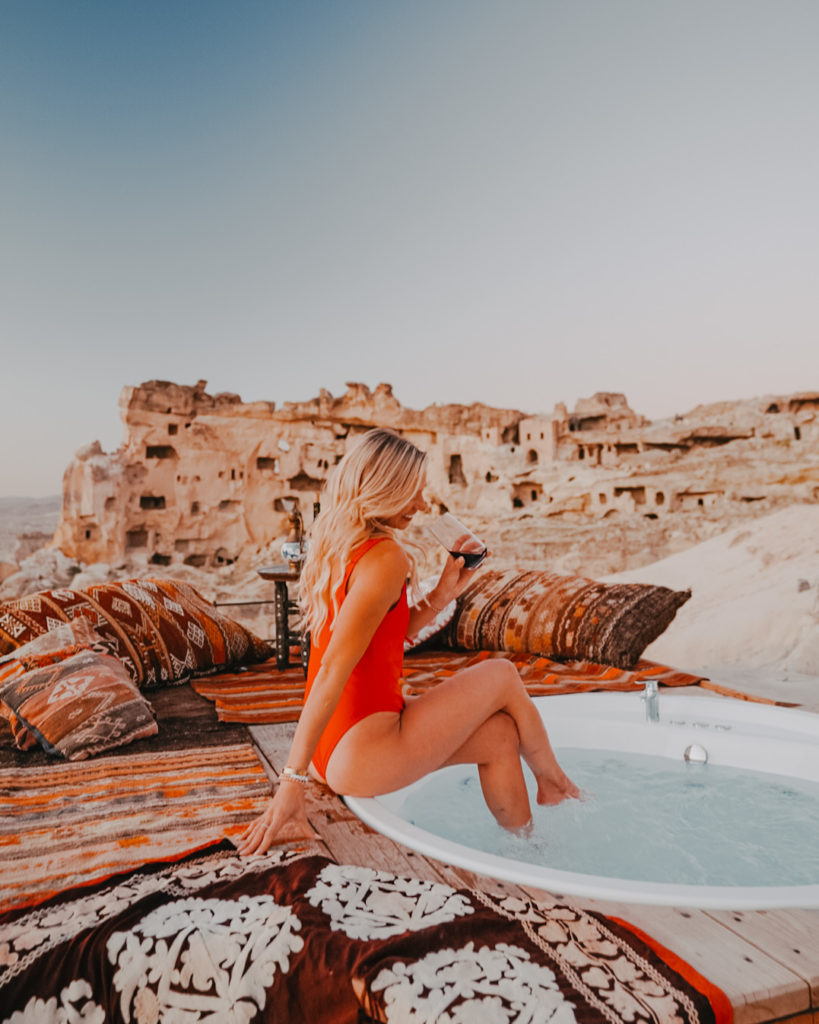 Girl in red swimsuit sitting in hot tub in Cappadocia